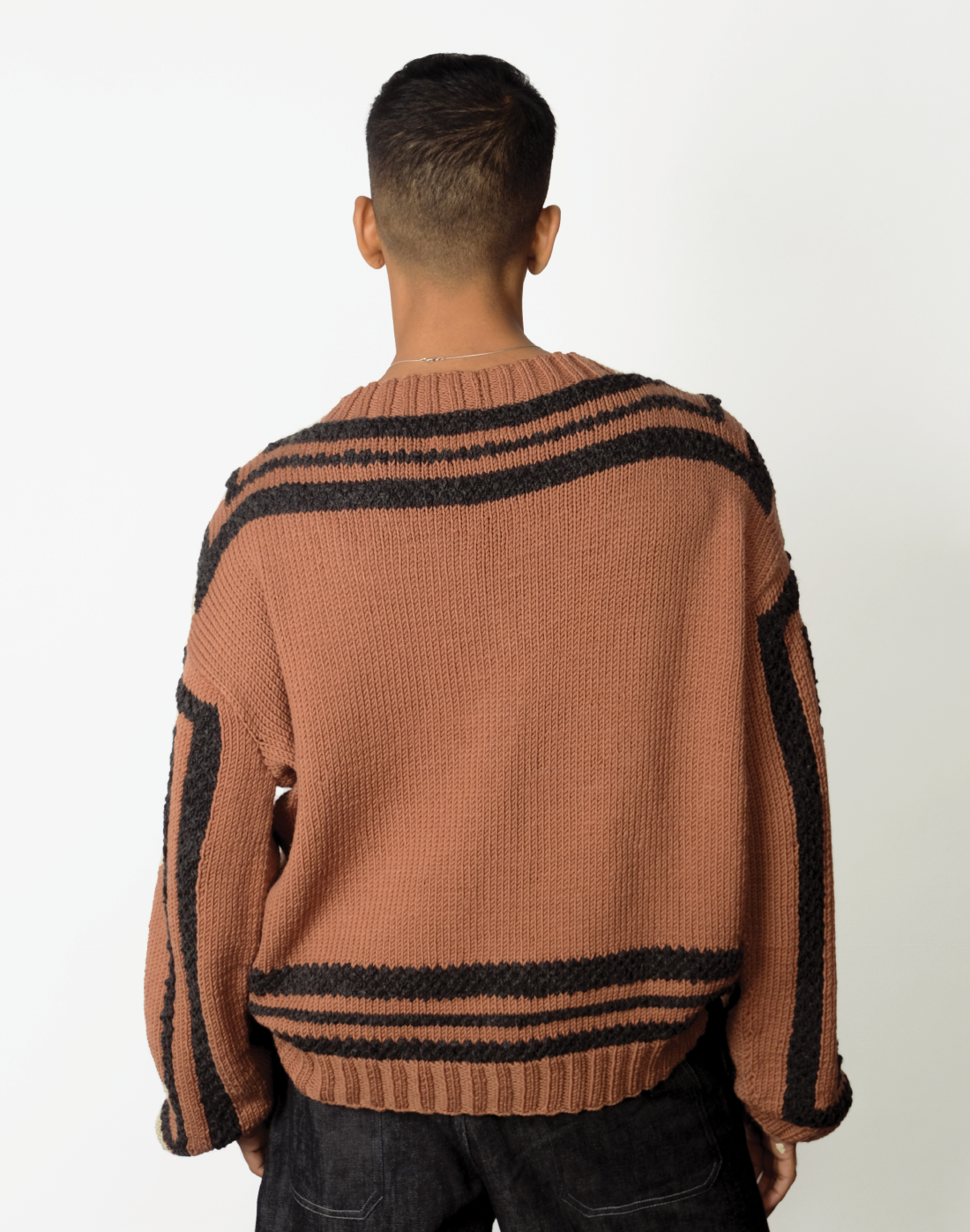 brown hand-knit wool cardigan with oversized fit, V-neck, and chunky grey knit outlines by Taarini Anand back