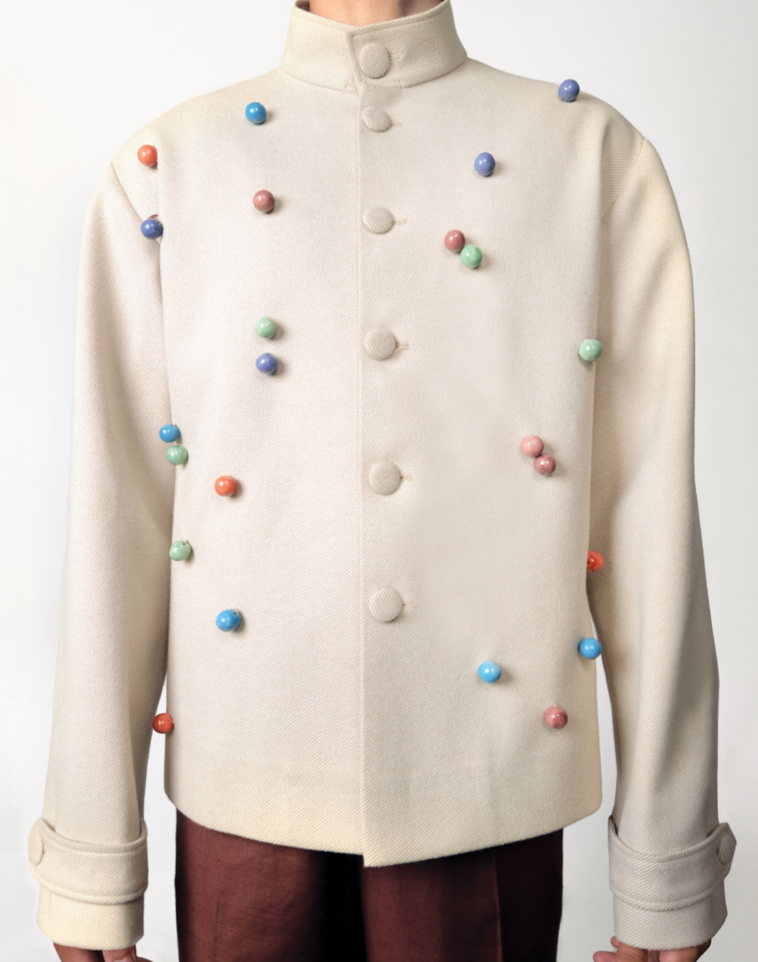 Artisanal wool twill jacket in beige with colourful handmade ceramic beads by Taarini Anand front