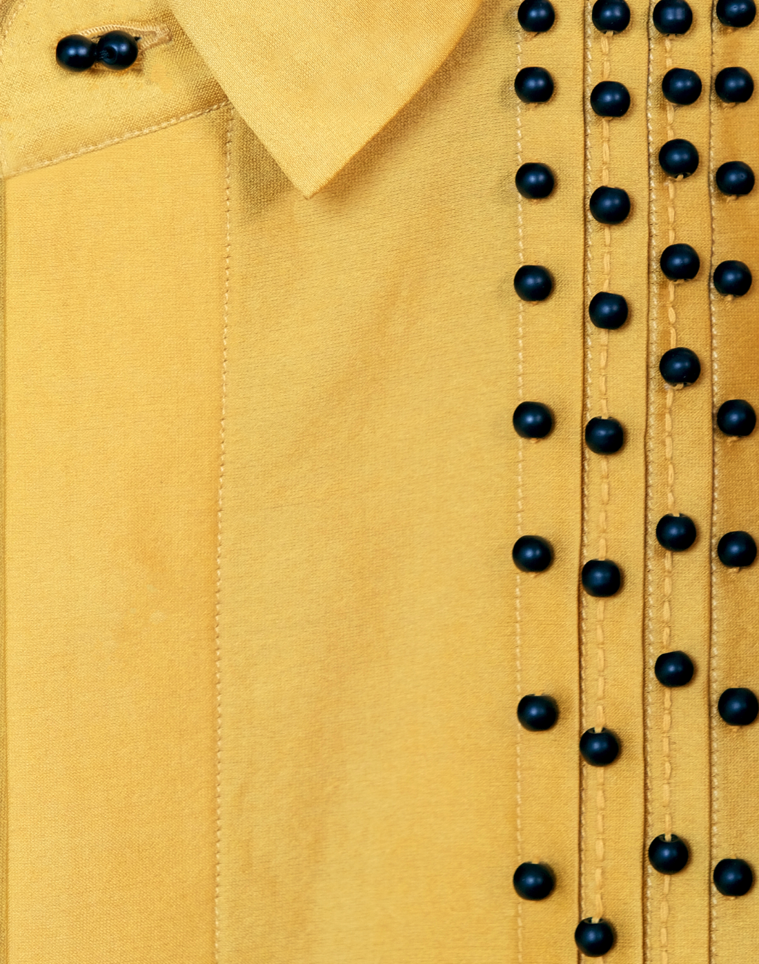 Taarini Anand Dilli Silk Shirt in mustard handloom silk with pintucks, kantha stitches and black glass bead embroidery close up