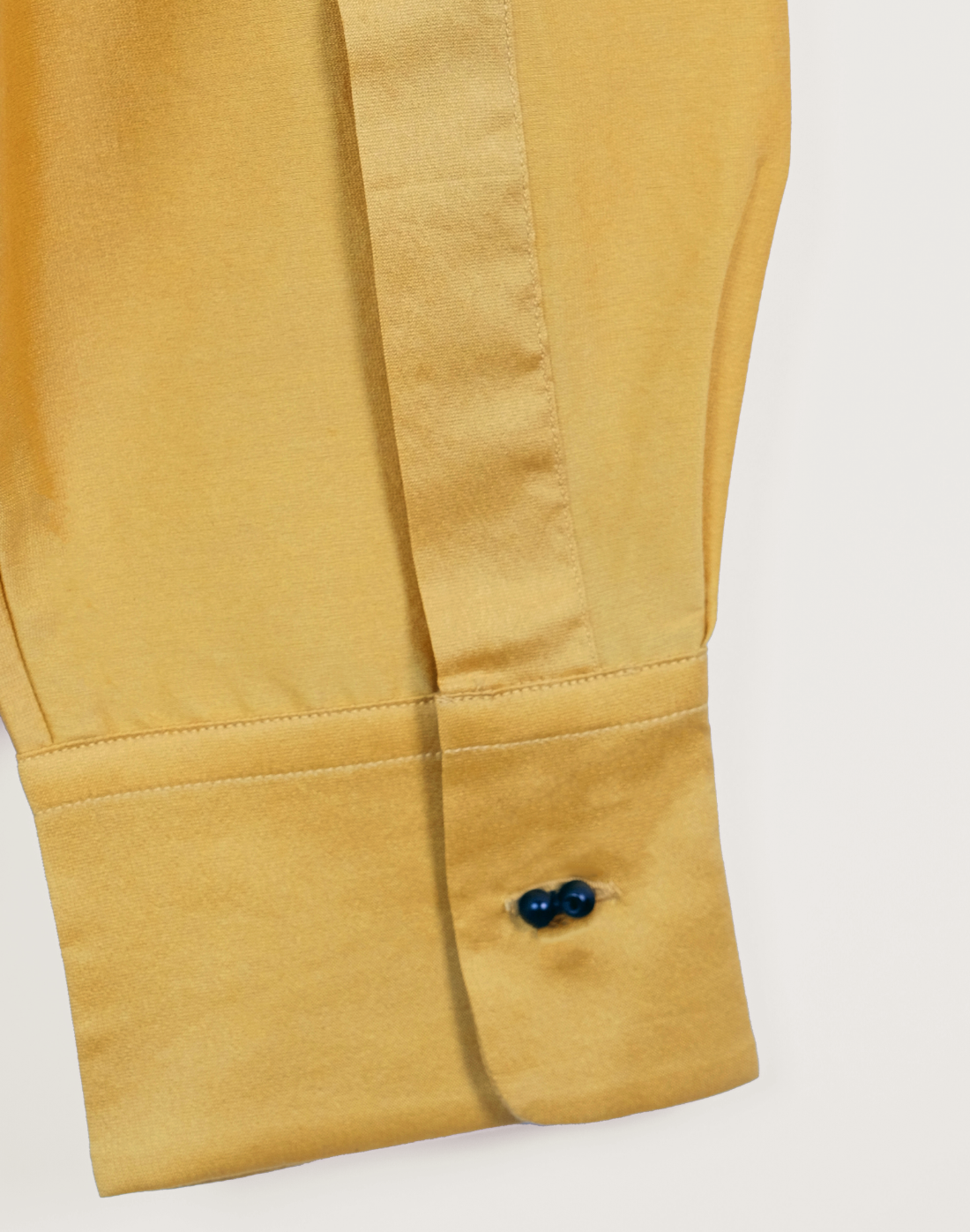 Taarini Anand Dilli Silk Shirt in mustard handloom silk with pintucks, kantha stitches and black glass bead embroidery cuff