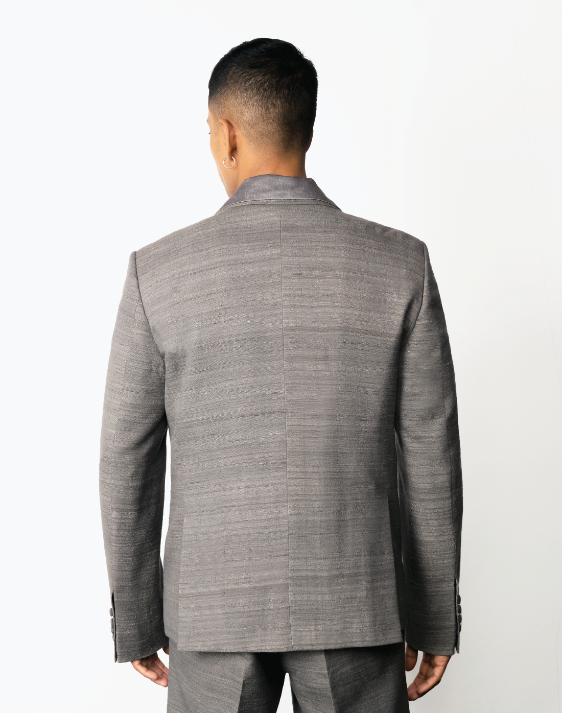 Grey handloom matka silk single-breasted blazer with notch lapels and patch pockets by Taarini Anand back