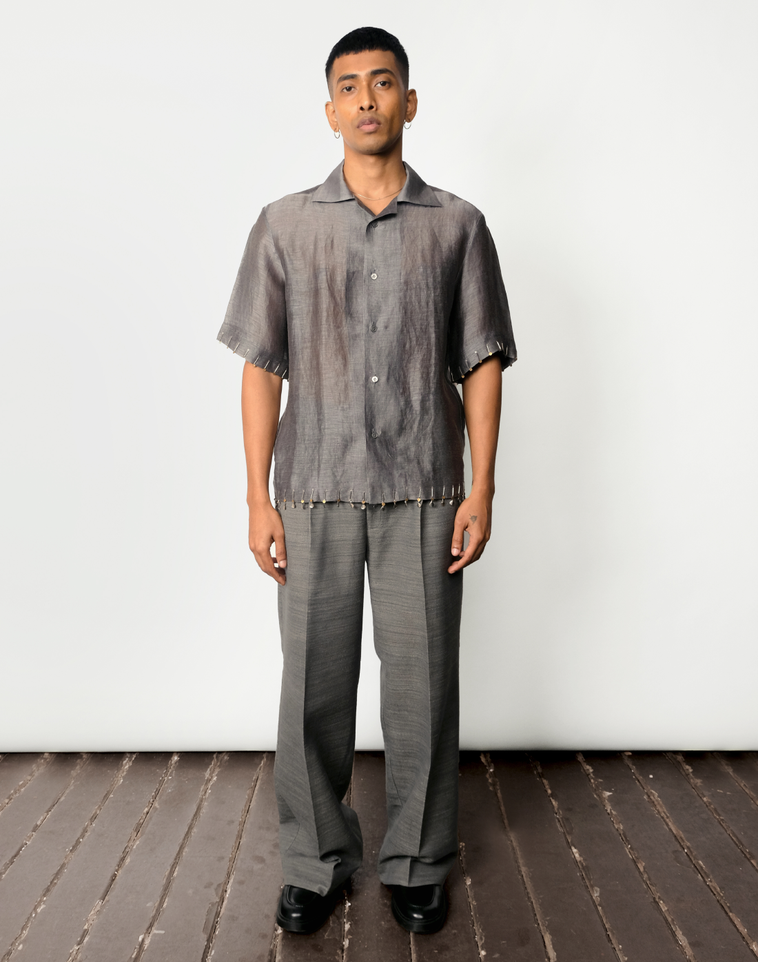 Grey silk-linen half-sleeved shirt with two-tone brass bead embroidery on hems by Taarini Anand