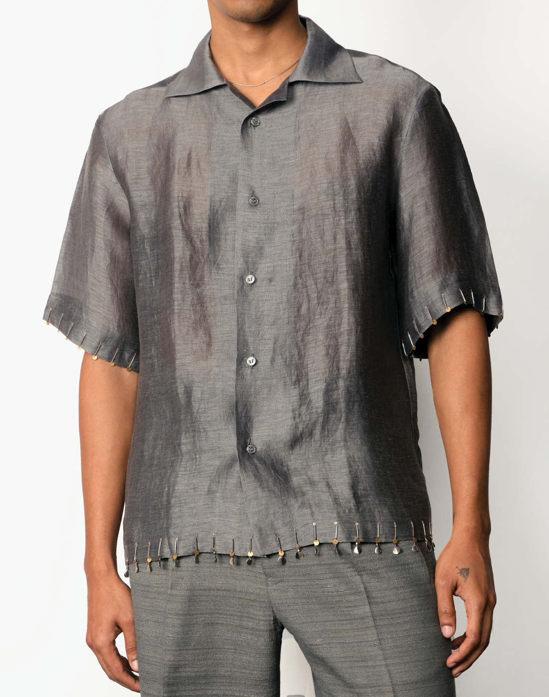 Grey silk-linen half-sleeved shirt with two-tone brass bead embroidery on hems by Taarini Anand front