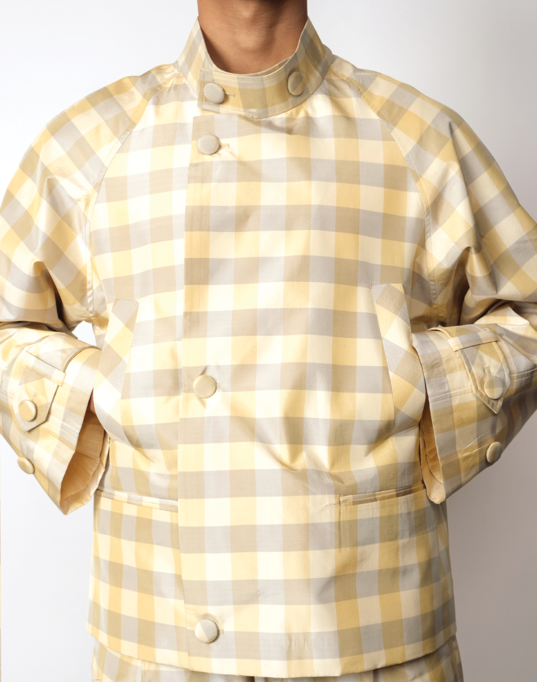Macro gingham silk taffeta jacket in green and yellow with raglan cut and cropped silhouette by Taarini Anand close up