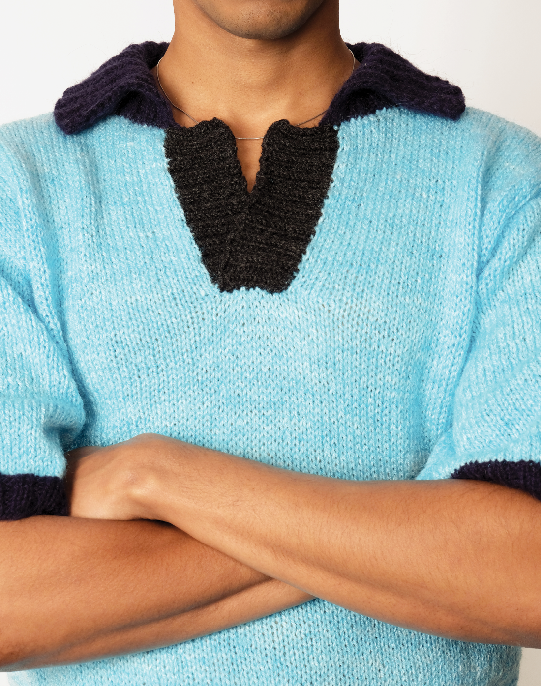 front Hand-knit sky-blue wool polo sweater with contrast navy collar by Taarini Anand