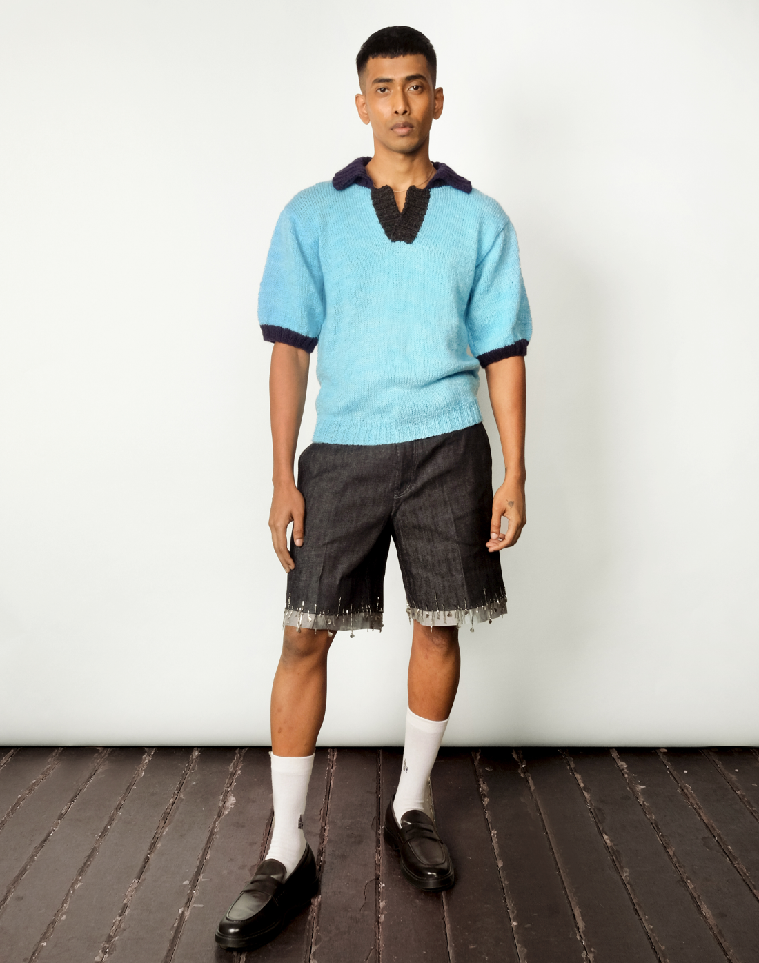 Sky-blue Marine Polo paired with embroidered singed denim shorts by Taarini Anand