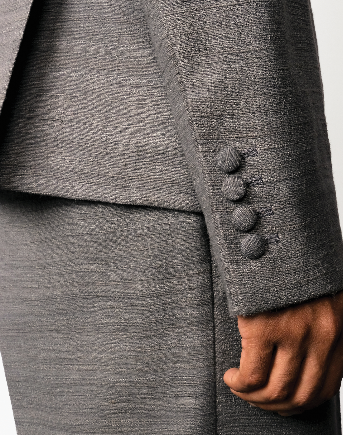 close up Taarini Anand Nocturne grey handloom silk trousers with pleated wide-leg silhouette and tailored finish