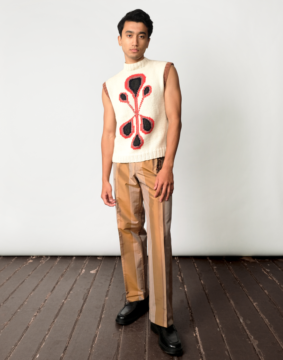 Taarini Anand outfit with Prism Logo Sweater Vest and Auric Stripe Trousers, bold intarsia knit and handloom stripes