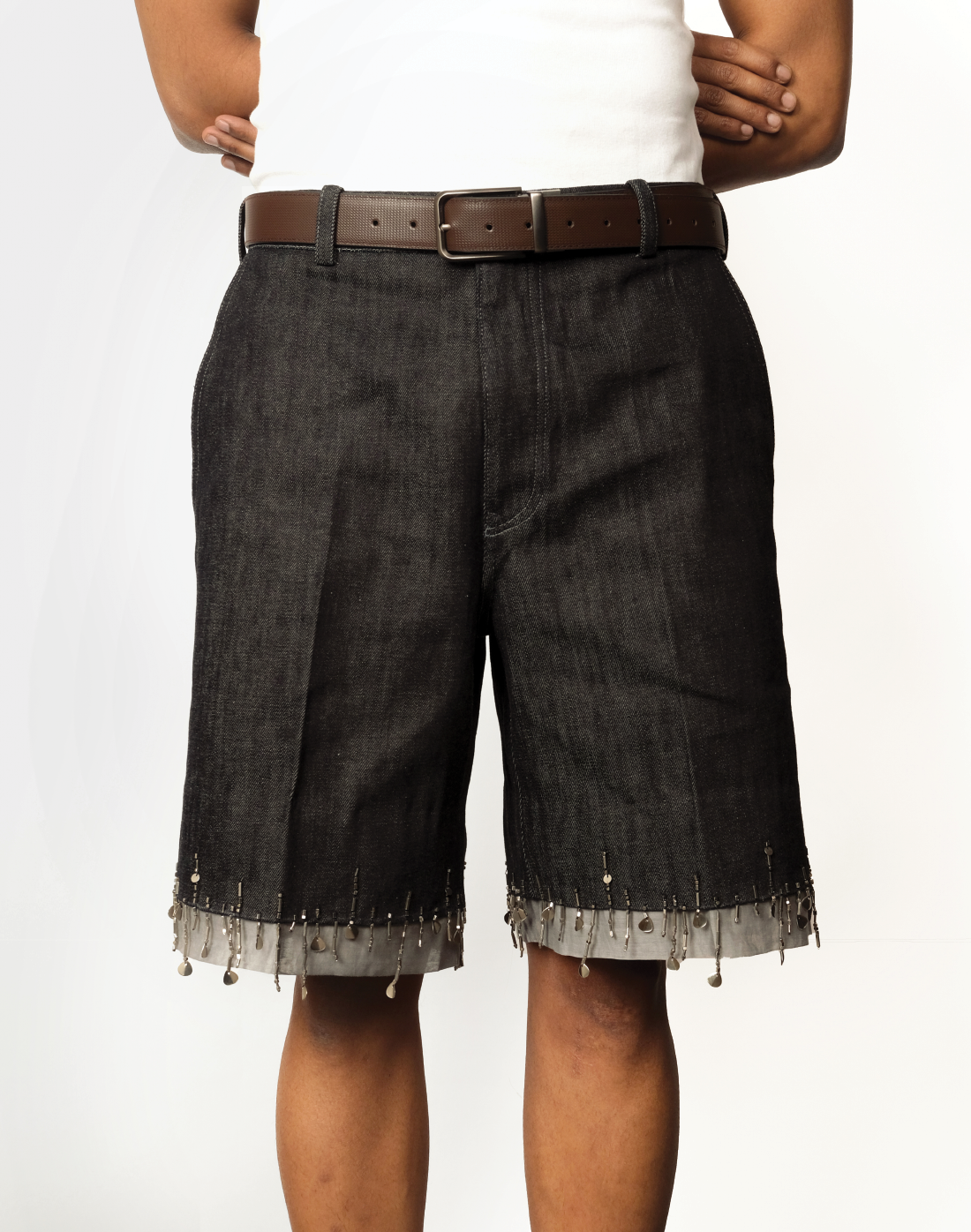 front view Taarini Anand singed-hem denim shorts with hand-embroidered bead tassels
