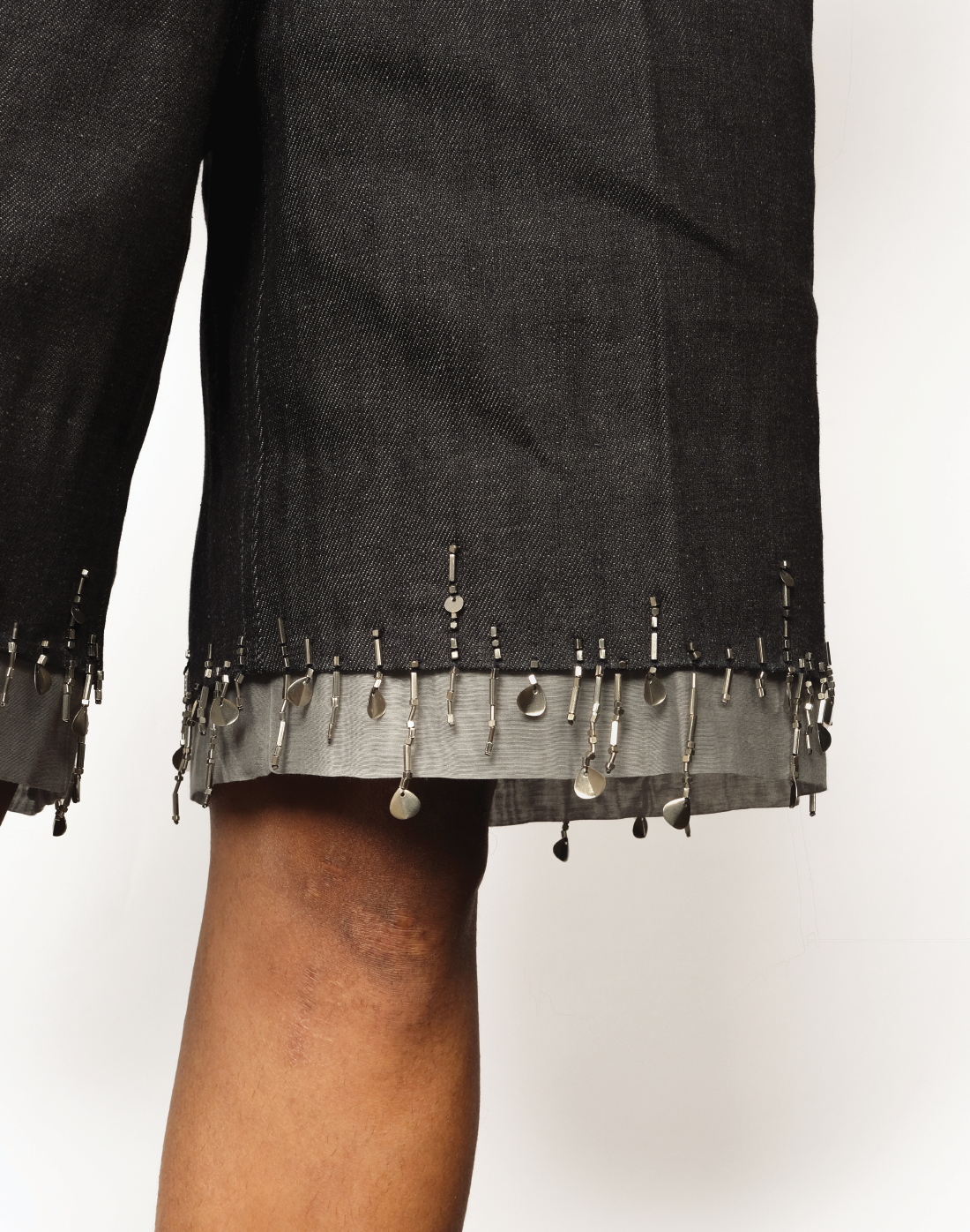 close up Taarini Anand singed-hem denim shorts with hand-embroidered bead tassels