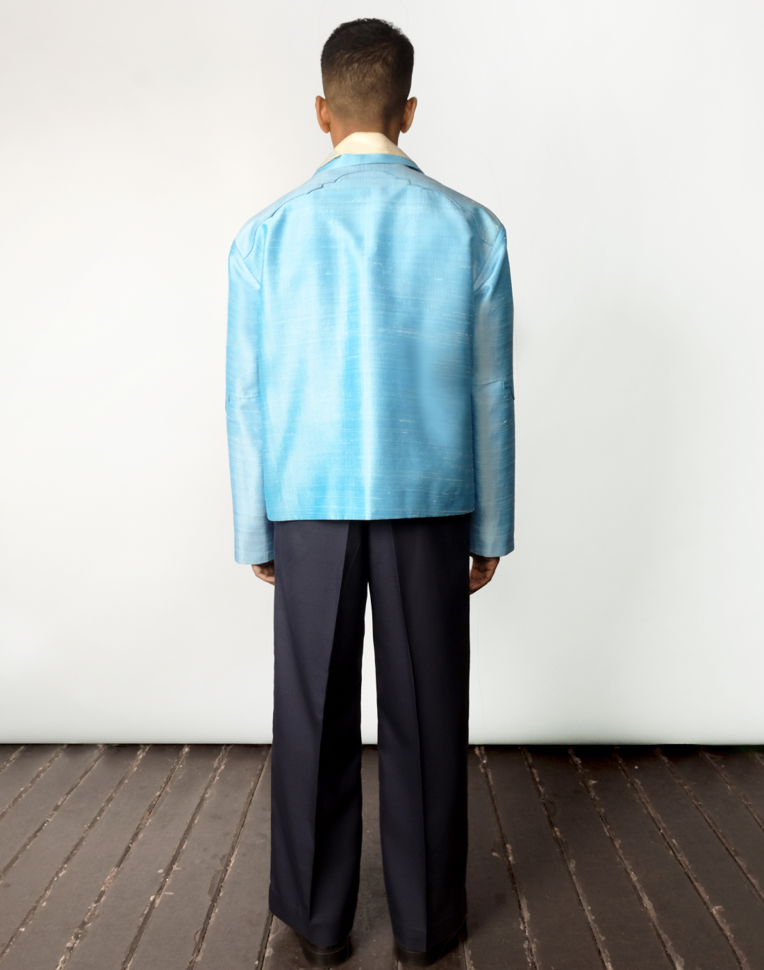 Sky blue raw silk jacket with dropped shoulders, arch-shaped yokes, and four patch pockets back